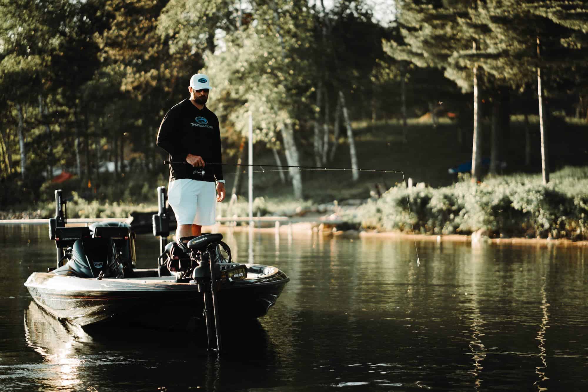 Man fishing off of a bass boat while using his trolling motor